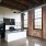 kitchen brightly lit by massive windows and overhead fixtures