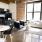 spacious, loft style apartment with concrete floors, brick walls and large windows