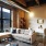 cozy and spacious living room with sconce lighting and large windows
